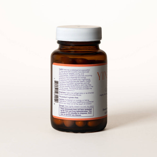 List of ingredients for CoEnzyme Q10 tablets on the back of a clear brown bottle