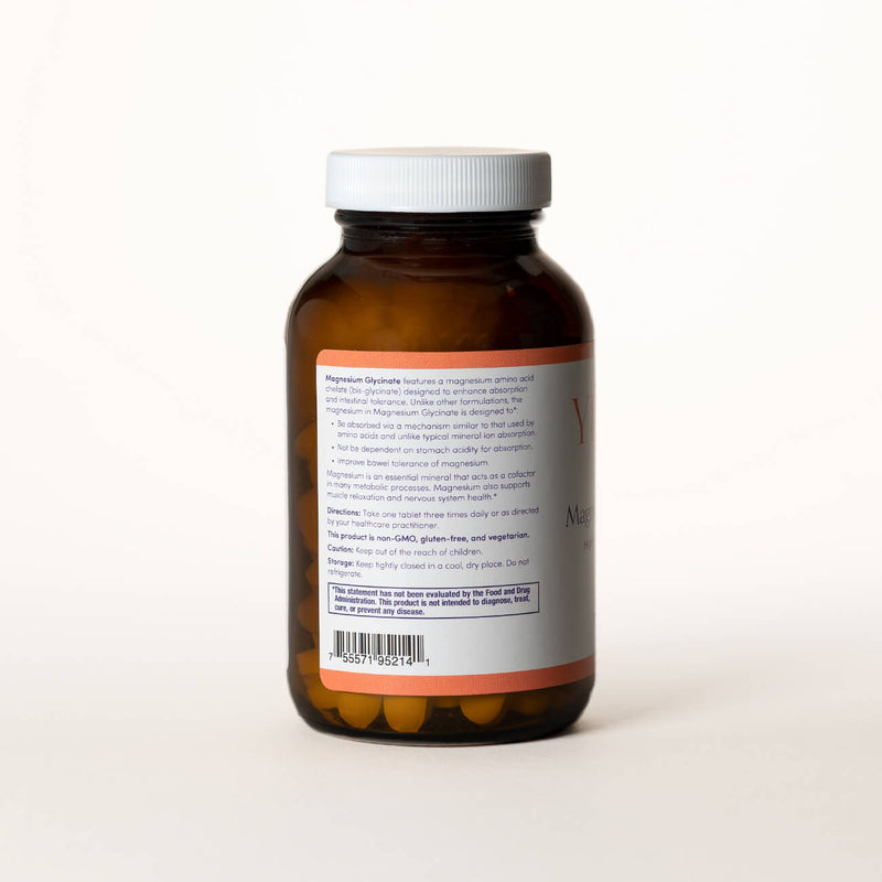 List of ingredients for Magnesium Glycinate tablets on the back of a clear brown bottle.