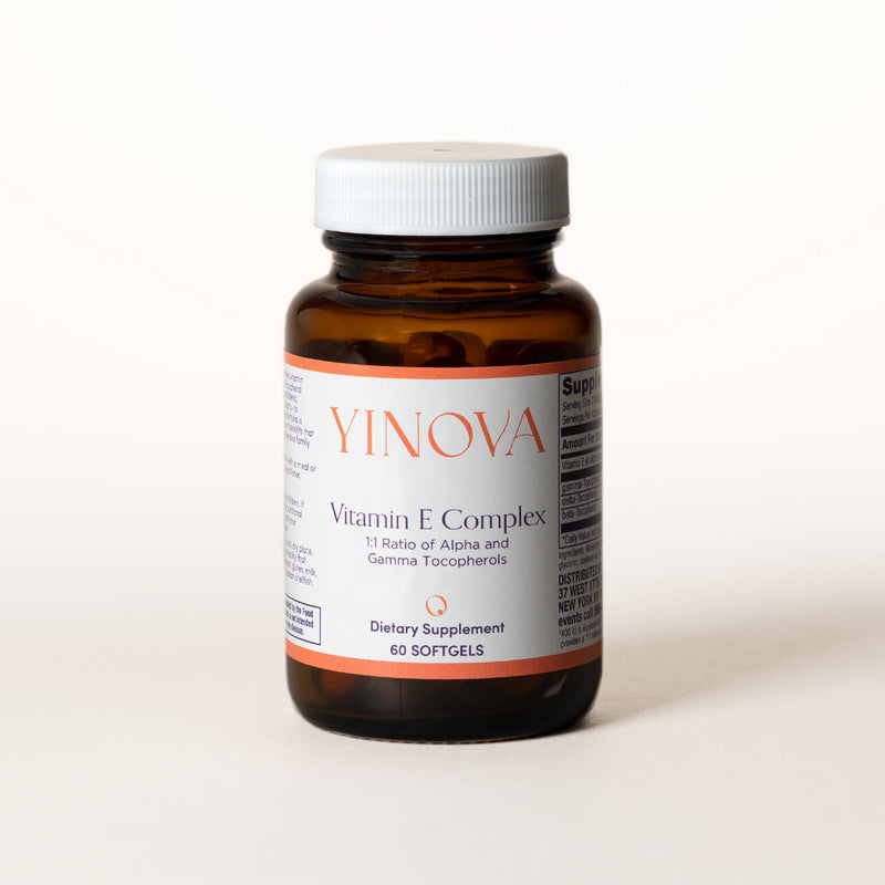 clear brown bottle containing Yinova’s blend of Vitamin E Complex tablets