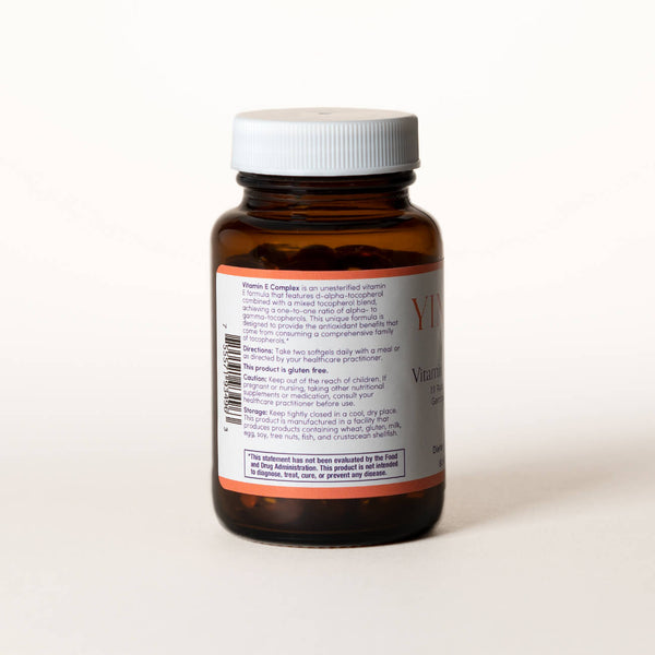 List of ingredients for Vitamin E Complex tablets on the back of a clear brown bottle.